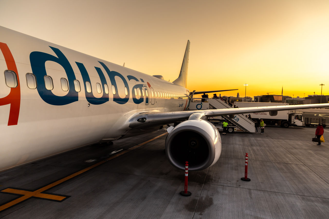 Airplane Flydubai Boeing 737-800 at Dubai International Airport at sunset, Dubai, United Arab Emirates